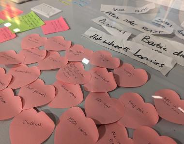 Photograph of heart-shaped post-it notes and paper saying things like 'Hot wheels lorries'